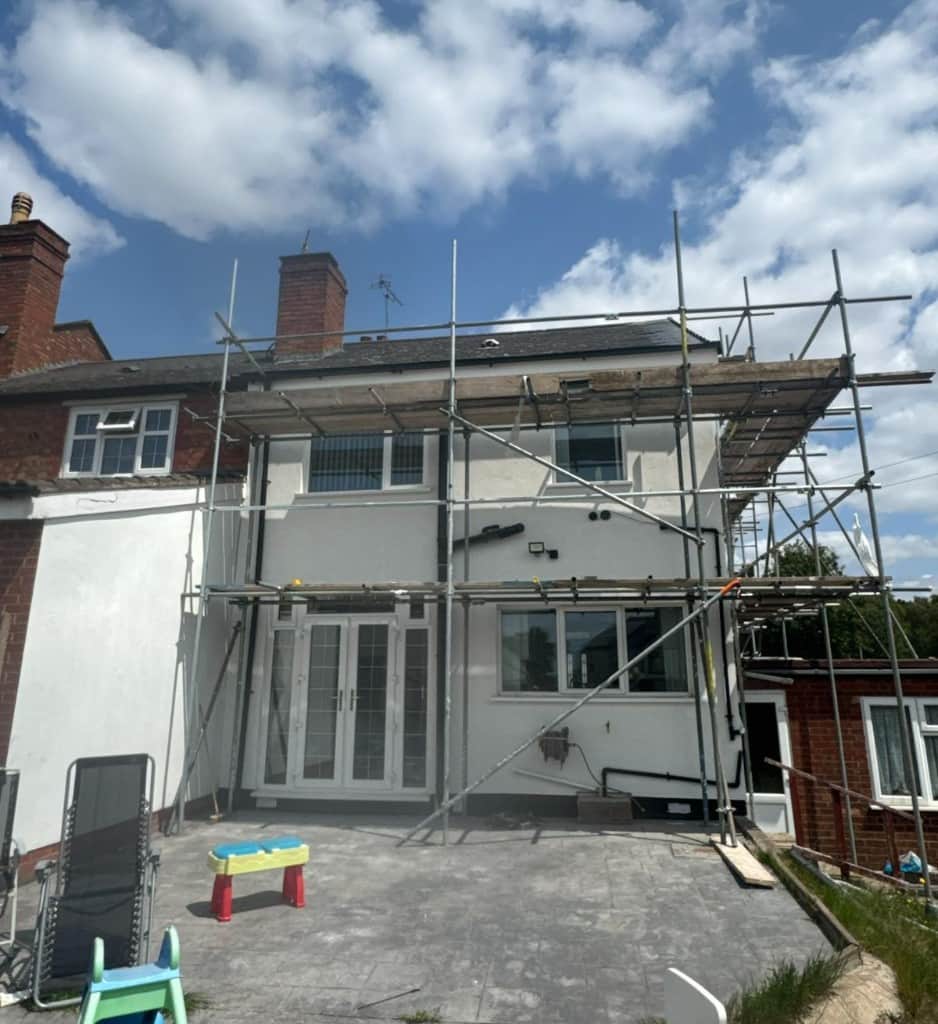 Mid-terrace house in Rowley Regis with scaffolding during external wall insulation