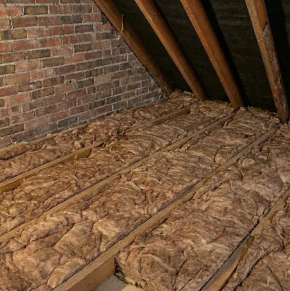 Mineral wool loft insulation fitted between joists on a Green Glow Insulation job